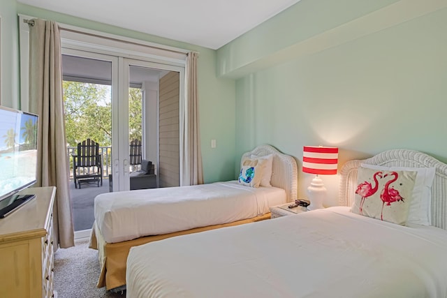 bedroom featuring french doors, access to outside, and carpet flooring