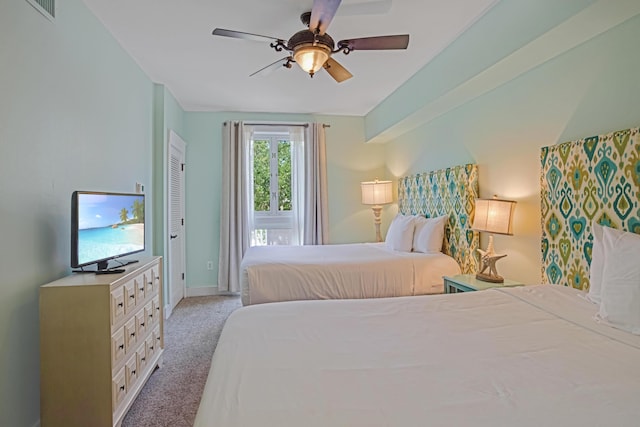 bedroom featuring light colored carpet and ceiling fan
