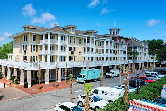 view of apartment building / complex with uncovered parking