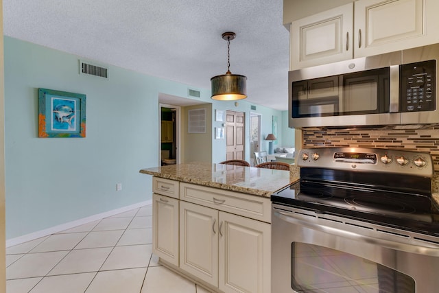 30 Moreno Point Rd Unit 206B, Destin, FL 32541 - kitchen featuring stainless steel appliances, hanging light fixtures, a peninsula, light stone counters, and a textured ceiling