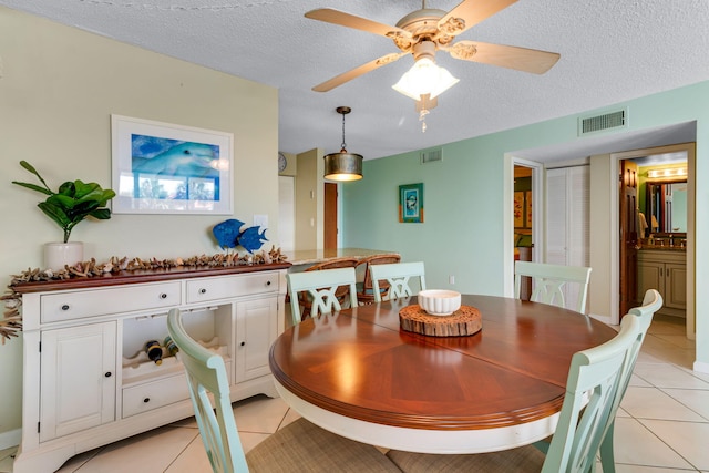 30 Moreno Point Rd Unit 206B, Destin, FL 32541 - dining room featuring light tile patterned floors, a ceiling fan, and a textured ceiling