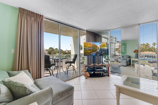 30 Moreno Point Rd Unit 206B, Destin, FL 32541 - living room featuring a wall of windows, plenty of natural light, tile patterned floors, and a textured ceiling
