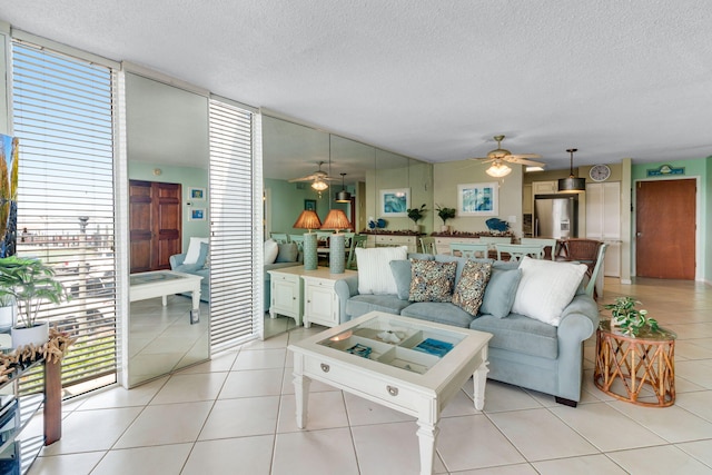 30 Moreno Point Rd Unit 206B, Destin, FL 32541 - living area with a ceiling fan, a textured ceiling, and light tile patterned floors