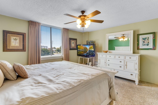 30 Moreno Point Rd Unit 206B, Destin, FL 32541 - bedroom with light colored carpet, a textured ceiling, and a ceiling fan