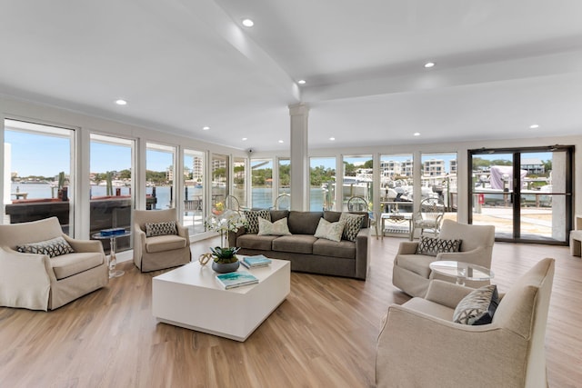30 Moreno Point Rd Unit 206B, Destin, FL 32541 - living area featuring plenty of natural light, a water view, ornate columns, light wood-style flooring, and recessed lighting