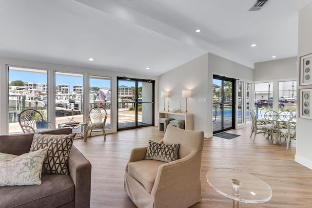 30 Moreno Point Rd Unit 206B, Destin, FL 32541 - living area featuring plenty of natural light, light wood-type flooring, recessed lighting, and baseboards