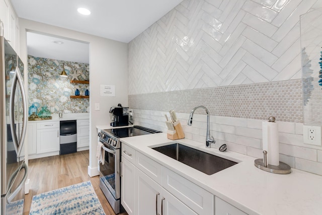 30 Moreno Point Rd Unit 206B, Destin, FL 32541 - kitchen with stainless steel appliances, a sink, backsplash, white cabinetry, and recessed lighting