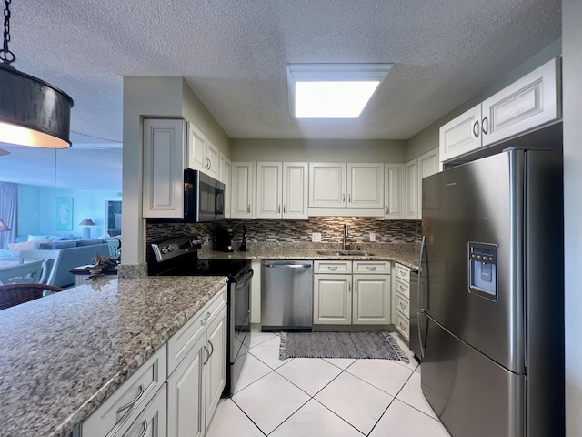 30 Moreno Point Rd Unit 206B, Destin, FL 32541 - kitchen with appliances with stainless steel finishes, a sink, backsplash, a textured ceiling, and light tile patterned floors