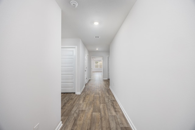 hall with wood finished floors, baseboards, and recessed lighting