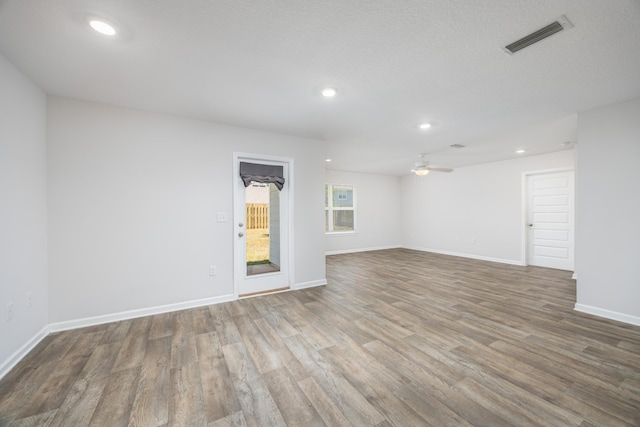 spare room with wood finished floors, ceiling fan, baseboards, and recessed lighting