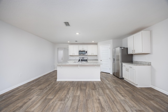 kitchen with stainless steel appliances, baseboards, white cabinets, dark wood-style floors, and recessed lighting