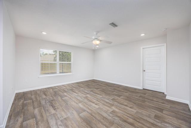 empty room featuring wood finished floors, ceiling fan, baseboards, and recessed lighting