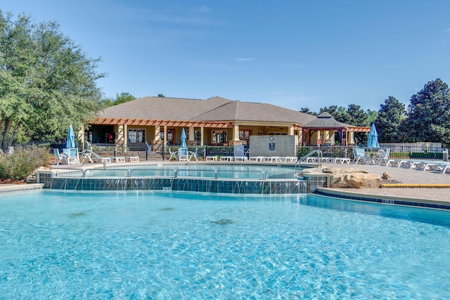 community pool with fence, a gazebo, and a patio area