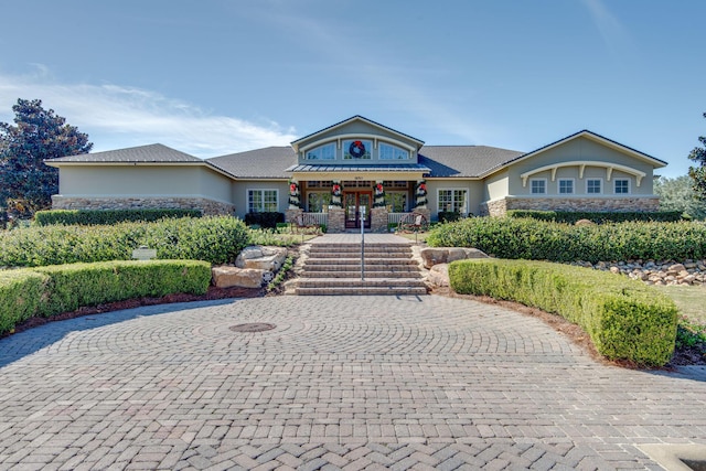 view of front of property with stone siding and stucco siding