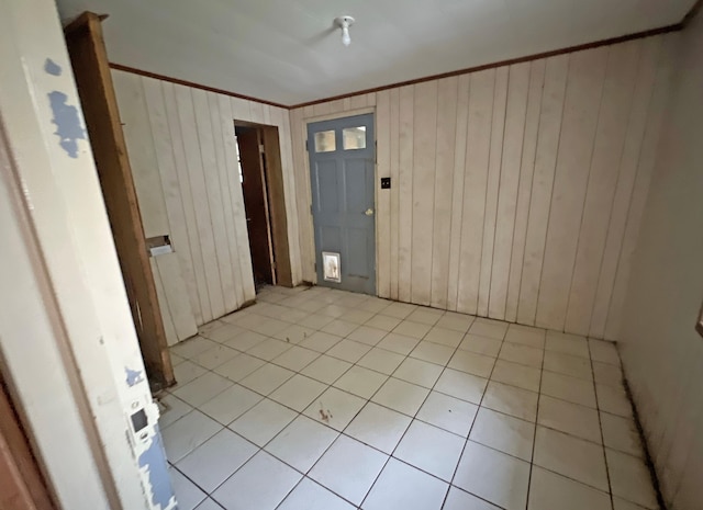 empty room with wood walls and ornamental molding