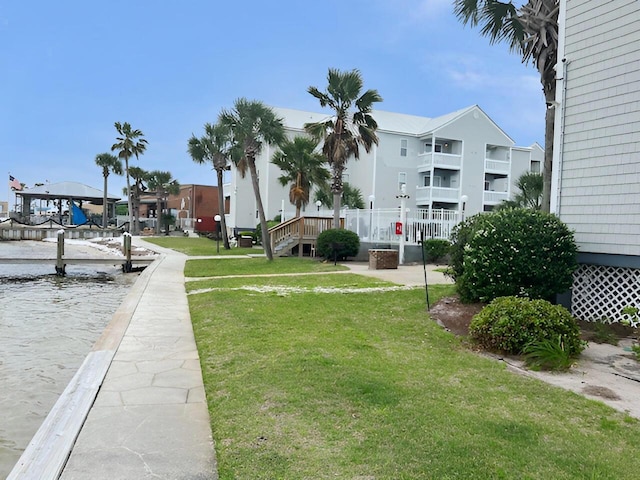 view of community featuring a lawn and a water view