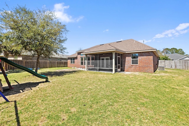 495 Brighton Cv, Freeport, FL 32439 - rear view of house featuring a sunroom, brick siding, a shingled roof, and cooling unit