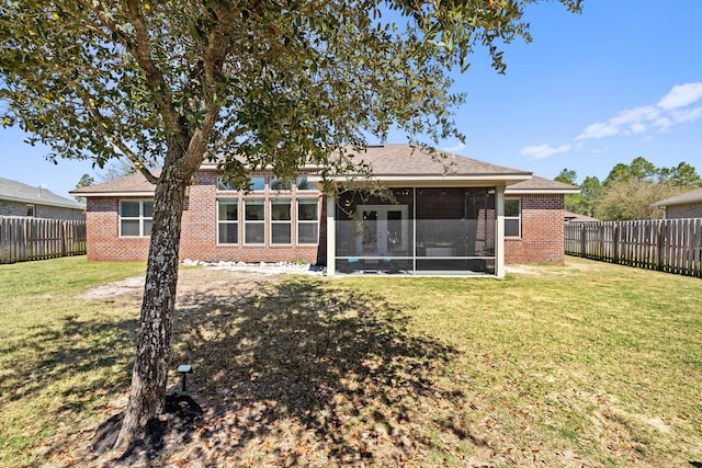 495 Brighton Cv, Freeport, FL 32439 - back of property featuring brick siding, a sunroom, and roof with shingles