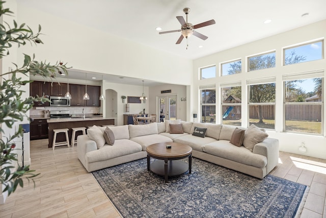 495 Brighton Cv, Freeport, FL 32439 - living room with arched walkways, ceiling fan, light wood-type flooring, recessed lighting, and a towering ceiling