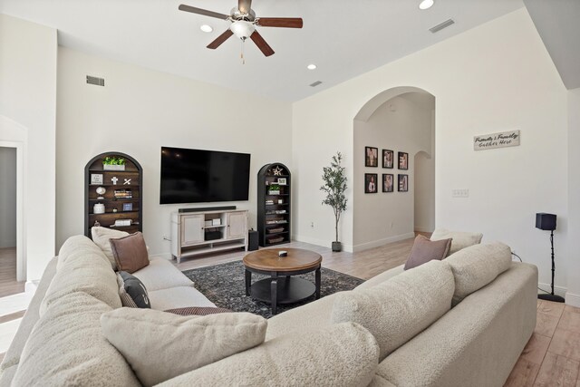 495 Brighton Cv, Freeport, FL 32439 - living area featuring arched walkways, ceiling fan, light wood finished floors, recessed lighting, and baseboards