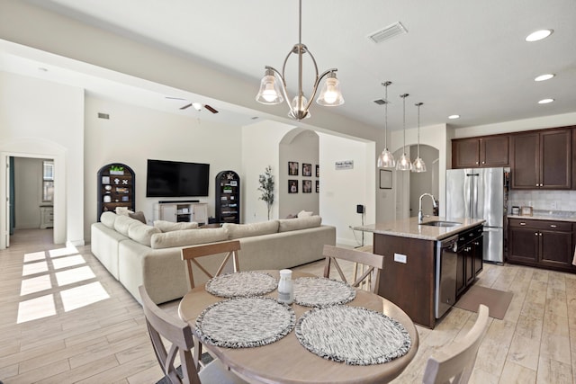 495 Brighton Cv, Freeport, FL 32439 - dining area featuring light wood-style flooring, recessed lighting, arched walkways, a chandelier, and ceiling fan
