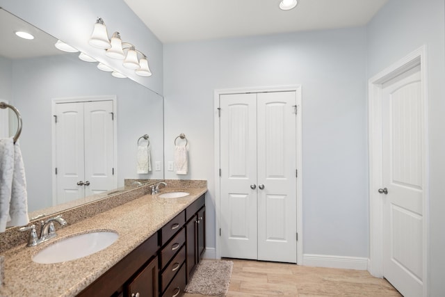 495 Brighton Cv, Freeport, FL 32439 - full bath featuring wood finished floors, double vanity, baseboards, and recessed lighting