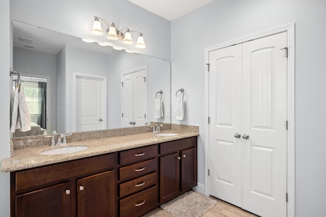 495 Brighton Cv, Freeport, FL 32439 - ensuite bathroom featuring double vanity and wood finished floors