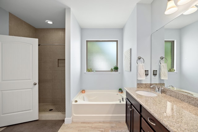 495 Brighton Cv, Freeport, FL 32439 - full bathroom with a bath, a tile shower, vanity, and wood finished floors
