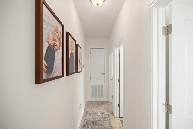 495 Brighton Cv, Freeport, FL 32439 - corridor with light wood-type flooring and baseboards