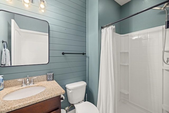 495 Brighton Cv, Freeport, FL 32439 - bathroom featuring toilet, a shower stall, vanity, and wooden walls