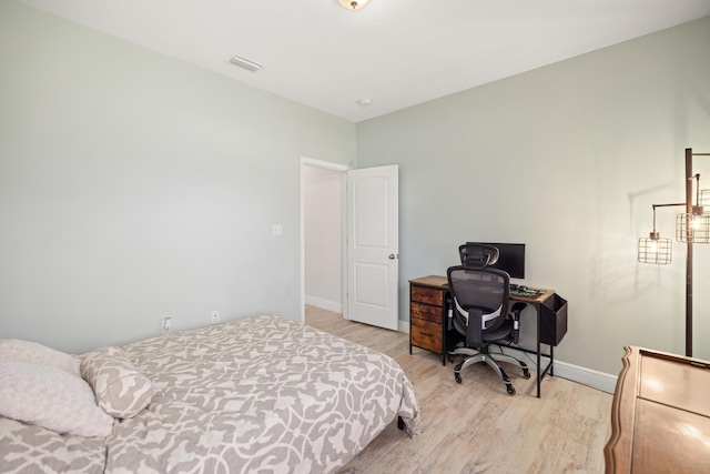 495 Brighton Cv, Freeport, FL 32439 - bedroom with light wood-style flooring, baseboards, and a desk