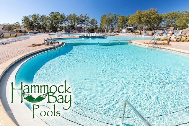 495 Brighton Cv, Freeport, FL 32439 - community pool with a patio area and fence