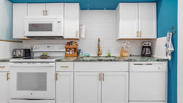 313 13th St, West Panama City Beach, FL 32413 - kitchen featuring white appliances, a sink, tasteful backsplash, and white cabinets