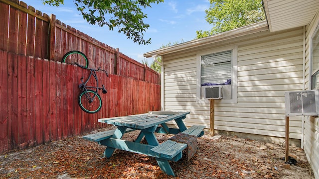 313 13th St, West Panama City Beach, FL 32413 - view of patio featuring fence and cooling unit