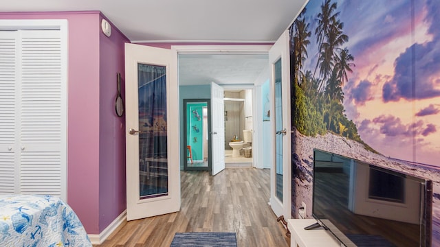 313 13th St, West Panama City Beach, FL 32413 - bedroom featuring wood finished floors, baseboards, and connected bathroom