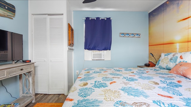 313 13th St, West Panama City Beach, FL 32413 - bedroom with wood finished floors, cooling unit, and a closet