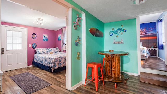 313 13th St, West Panama City Beach, FL 32413 - bedroom featuring wood finished floors, baseboards, and a textured ceiling