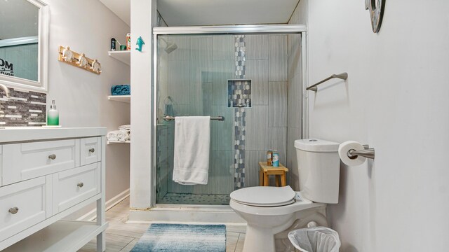 313 13th St, West Panama City Beach, FL 32413 - bathroom with toilet, a stall shower, vanity, and decorative backsplash