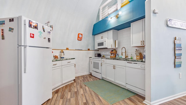 313 13th St, West Panama City Beach, FL 32413 - kitchen with white appliances, a sink, light wood-style floors, and white cabinets