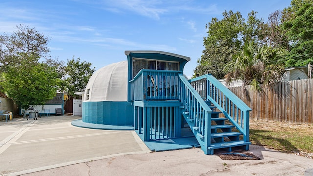 313 13th St, West Panama City Beach, FL 32413 - view of front of home with fence and stairway