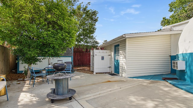 313 13th St, West Panama City Beach, FL 32413 - view of patio / terrace featuring a fenced backyard, an outdoor structure, and a storage unit