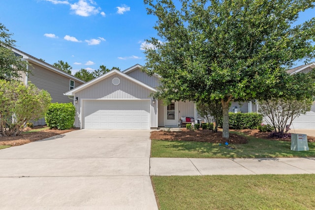595 Earl Godwin Rd, Freeport, FL 32439 - view of front of home featuring an attached garage, driveway, and a front yard