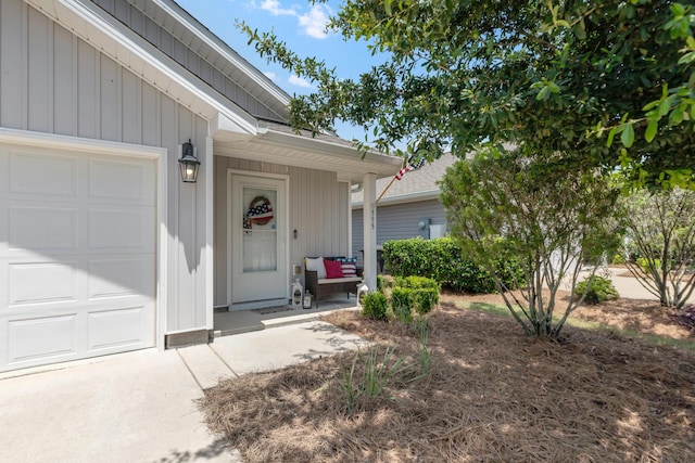 595 Earl Godwin Rd, Freeport, FL 32439 - doorway to property with board and batten siding and an attached garage