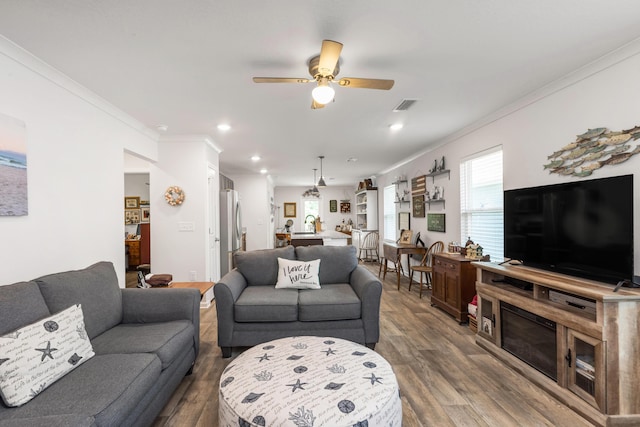 595 Earl Godwin Rd, Freeport, FL 32439 - living area with crown molding, dark wood-style flooring, ceiling fan, and recessed lighting