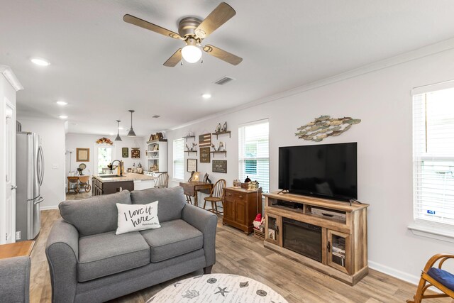 595 Earl Godwin Rd, Freeport, FL 32439 - living room with ornamental molding, light wood finished floors, ceiling fan, recessed lighting, and baseboards