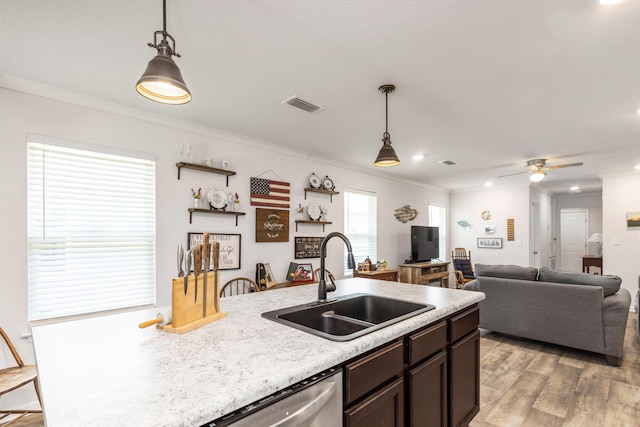 595 Earl Godwin Rd, Freeport, FL 32439 - kitchen featuring a sink, ornamental molding, light wood-style flooring, light countertops, and hanging light fixtures