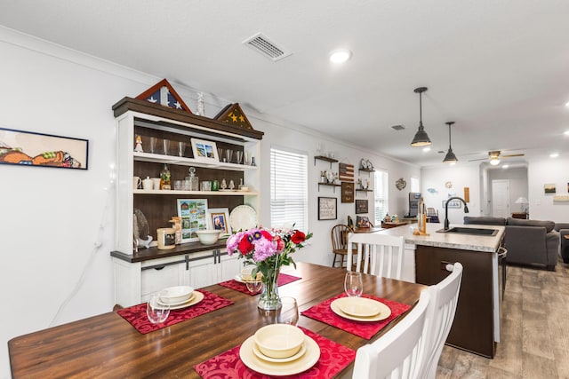 595 Earl Godwin Rd, Freeport, FL 32439 - dining space featuring ornamental molding, light wood-style floors, ceiling fan, and recessed lighting