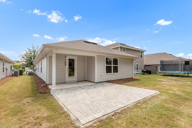 595 Earl Godwin Rd, Freeport, FL 32439 - back of house with a trampoline, a patio area, cooling unit, and a yard