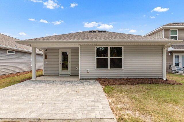 595 Earl Godwin Rd, Freeport, FL 32439 - back of house featuring a patio, a yard, and roof with shingles