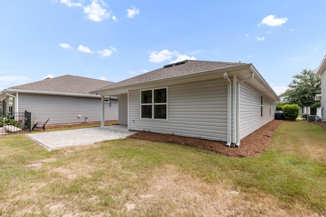 595 Earl Godwin Rd, Freeport, FL 32439 - rear view of house with a patio area, central AC unit, a yard, and roof with shingles